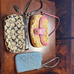 Coach Signature Clutches in Black, Tan, and Blue